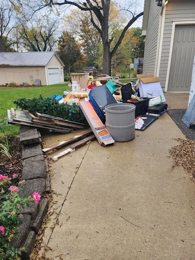 Dumpster being loaded with debris for Estate Cleanout Dumpster Rental in Chaparral